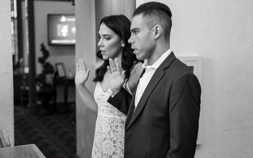 A bride and groom taking their oath before their civil ceremony at the old orange county courthouse in Santa Ana. 