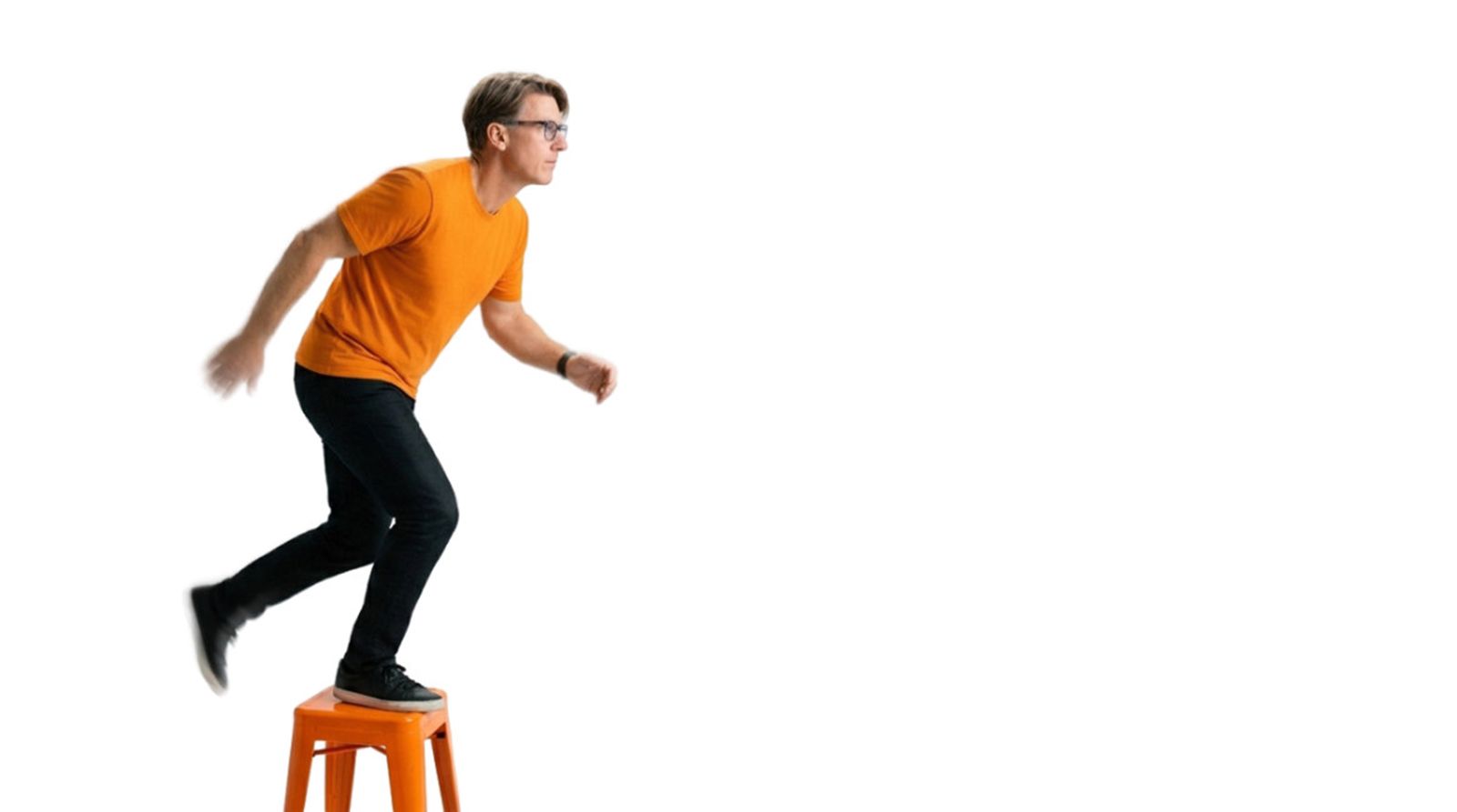 Christopher Todd in a blue shirt is holding a camera and smiling.