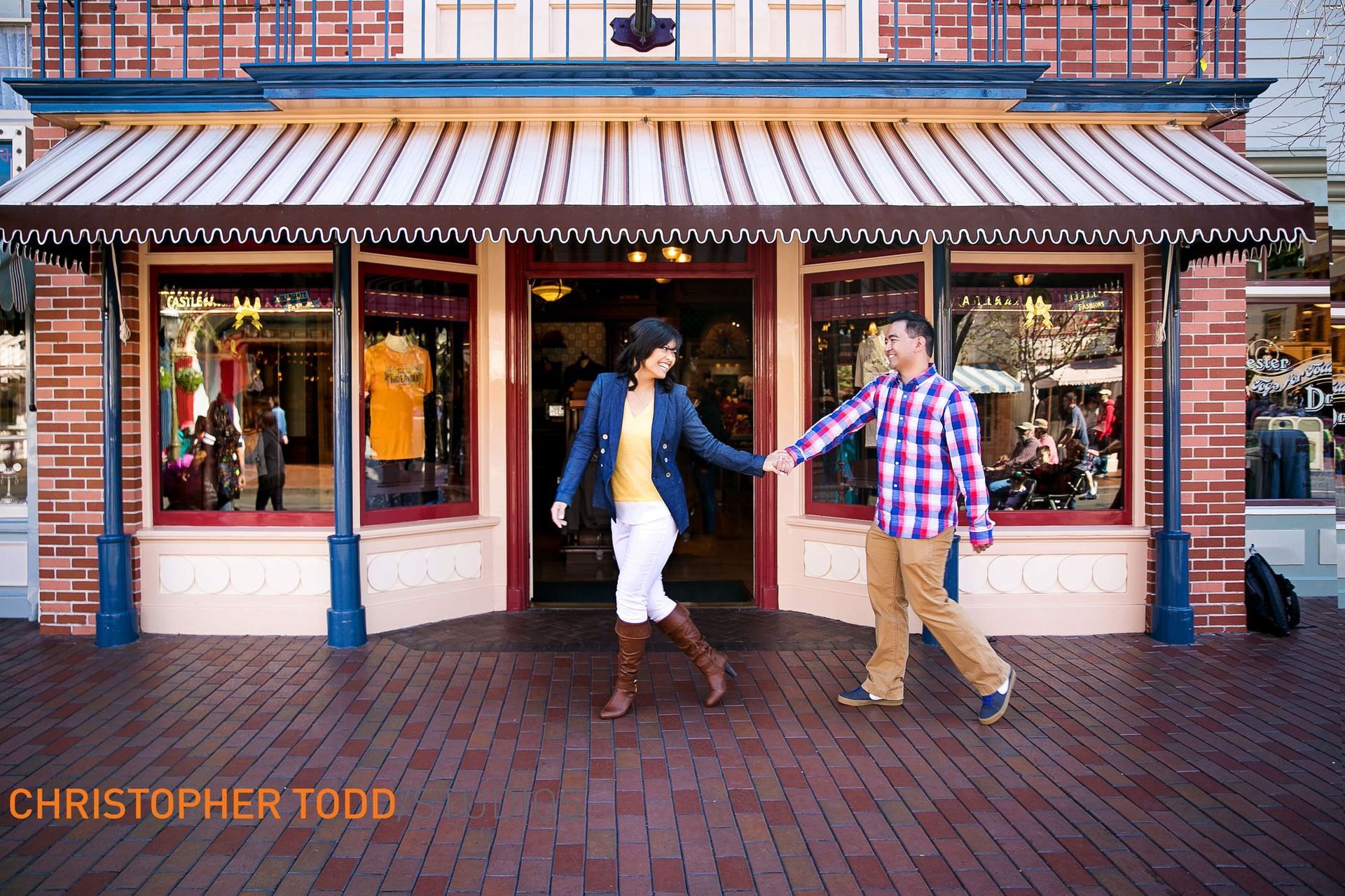 A man and a woman are holding hands in front of a store by christopher todd