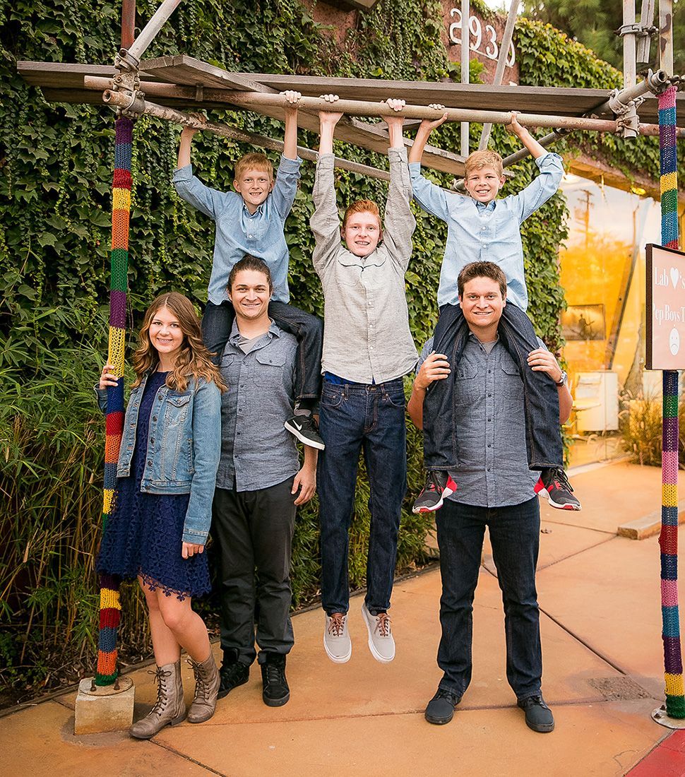 A group of kids are standing next to each other on a scaffolding.