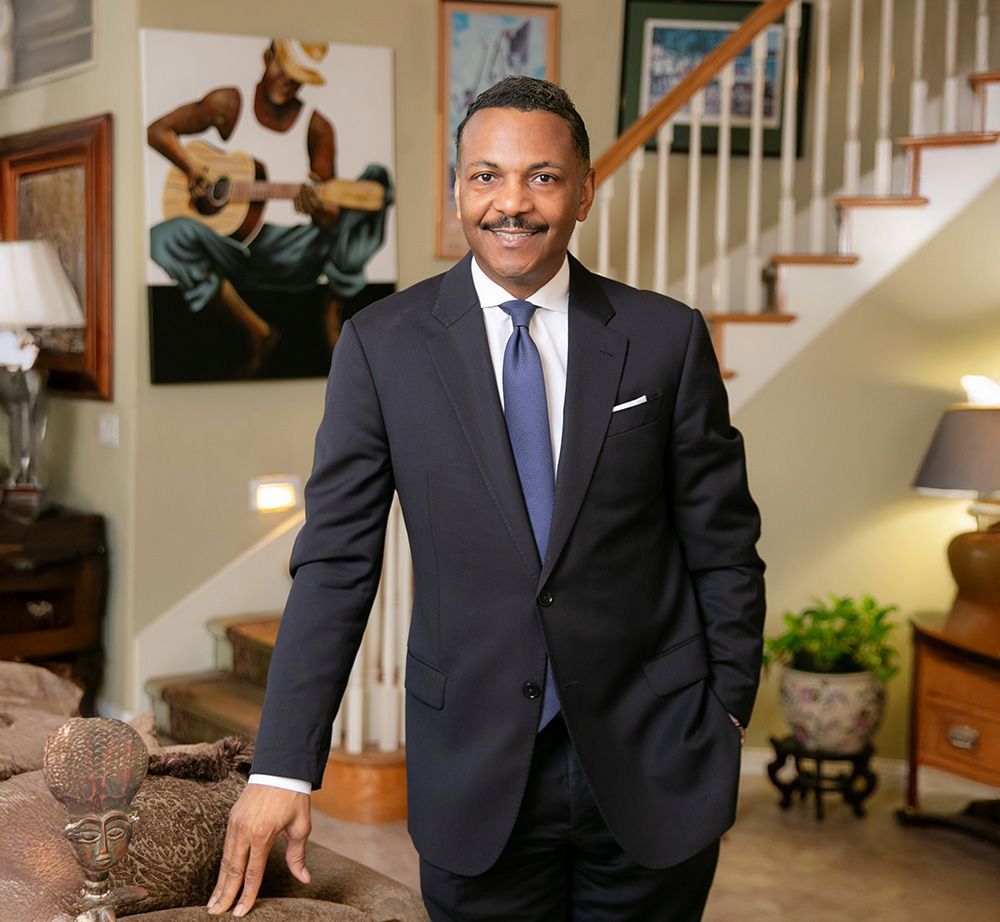 A man in a suit and tie is standing in a living room