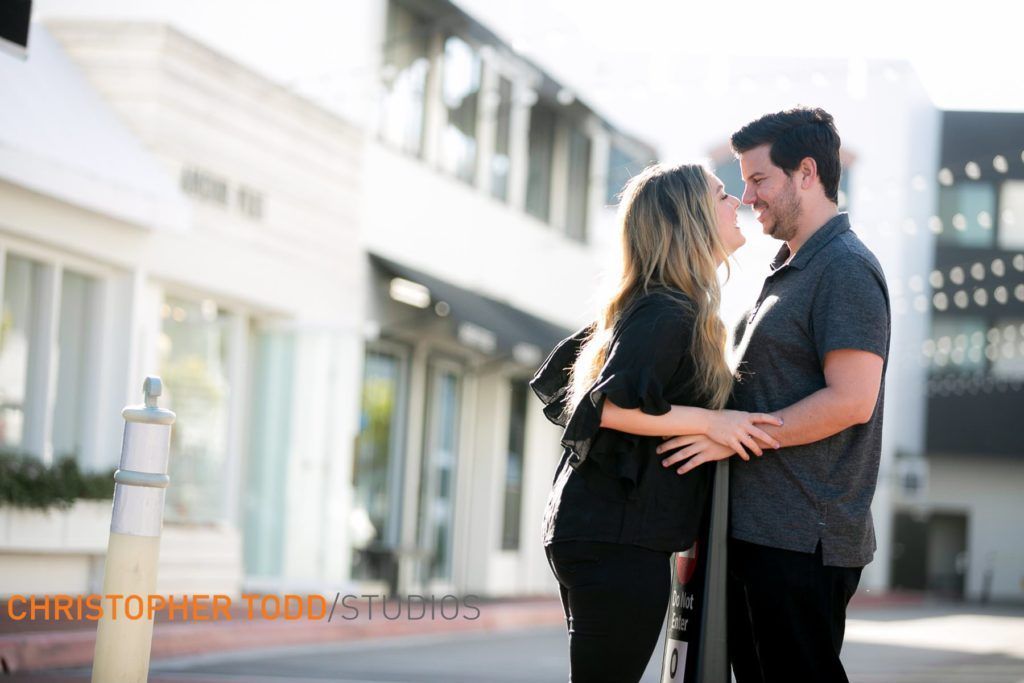 A man and a woman are kissing in front of a building at Lido Marina Village