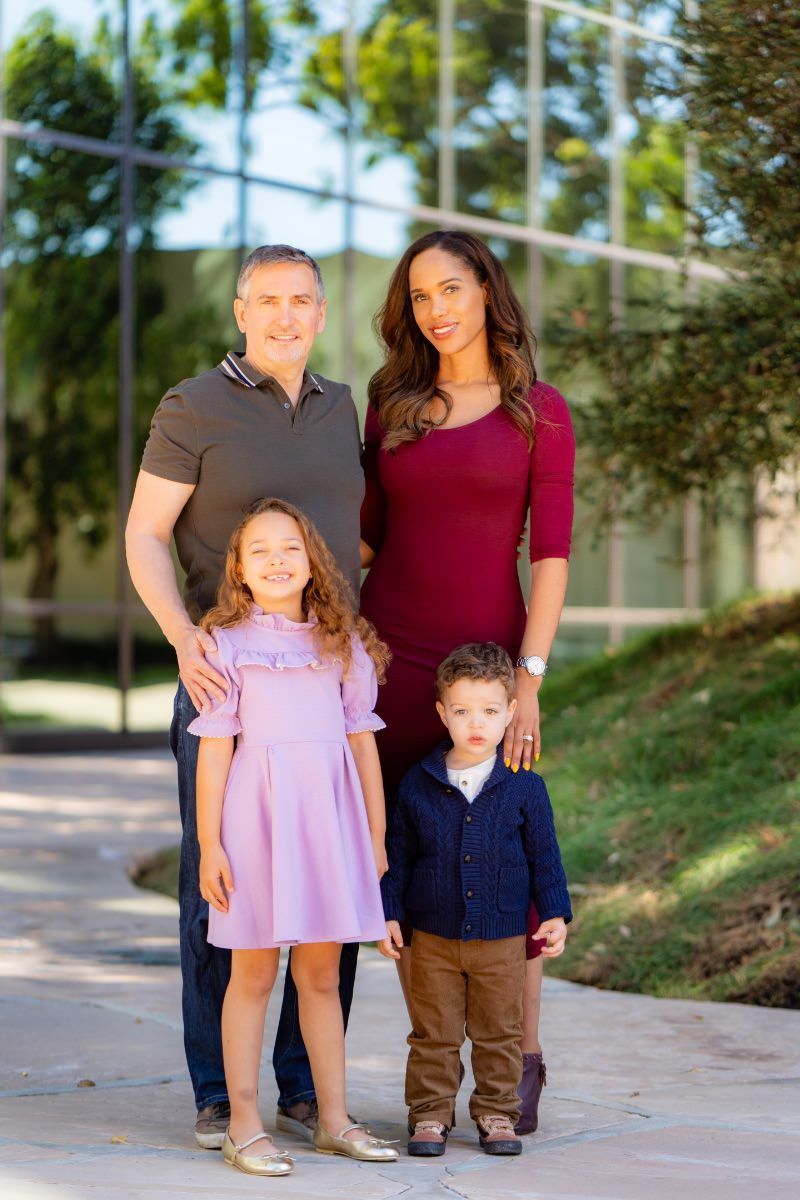 A family is posing for a picture at Noguchi Gardens in Costa Mesa