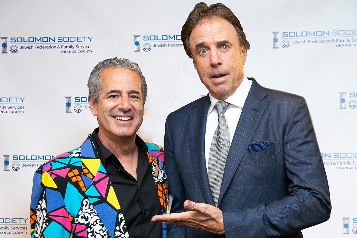 Two men are posing for a picture in on the red carpet