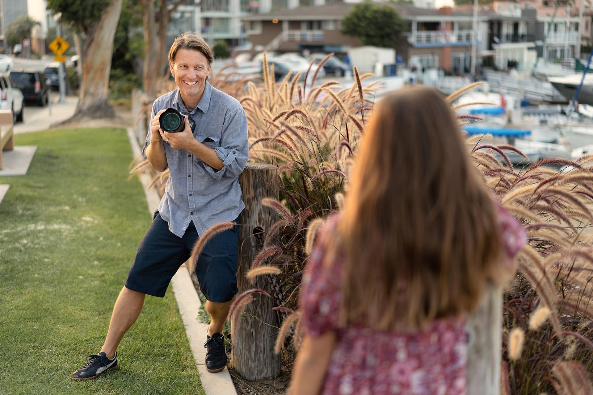 Christopher Todd is taking a picture of a girl with a camera.