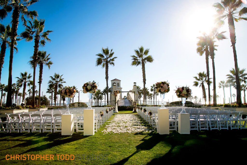 Hyatt Huntington Beach Wedding A photo of a wedding ceremony taken with palm trees and ocean views