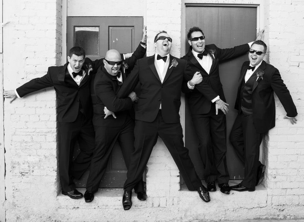 A man in a suit and tie is smiling for the camera