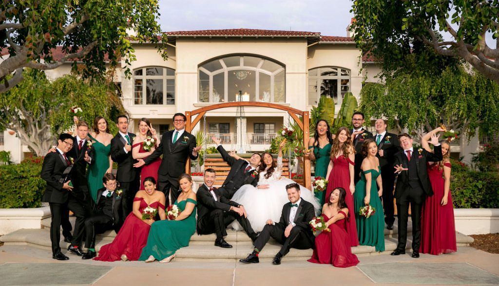 A large wedding party is posing for a picture Hyatt Park Aviara 