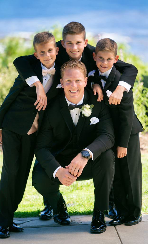 The groom and his groomsmen are posing for a picture together.