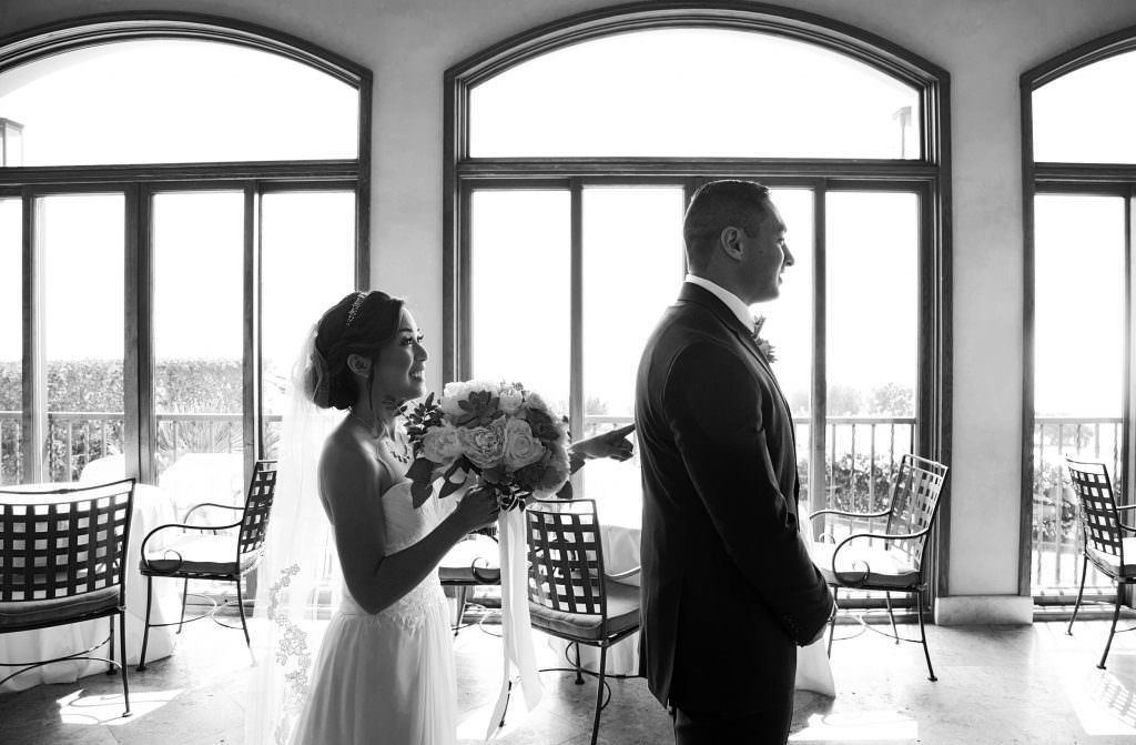 A bride taps her groom doing a first look before their wedding in Los Angeles