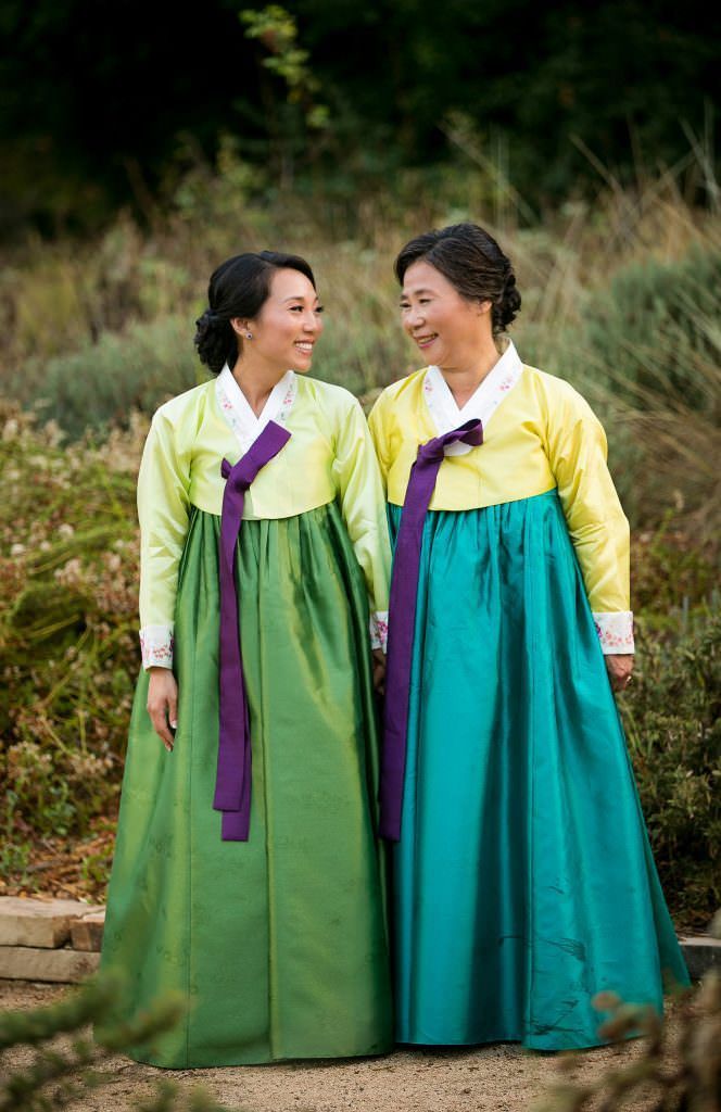 Two women in traditional korean dresses are standing next to each other.