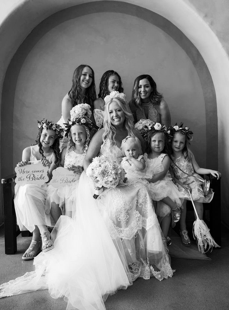 A bride and her bridesmaids are posing at Hyatt Huntington Beach in Orange County