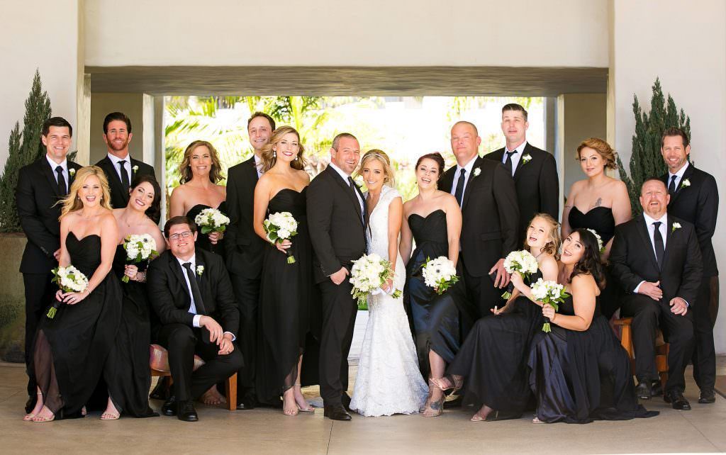 A bride and groom pose with their wedding party