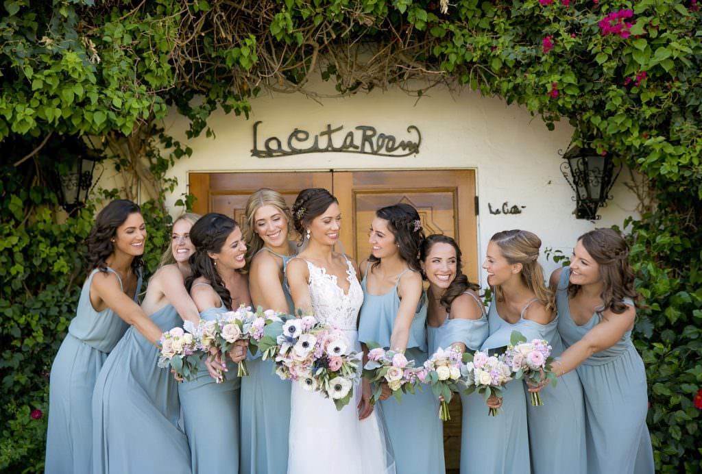 A bride and her bridesmaids are posing at the La Quinta Resort 
