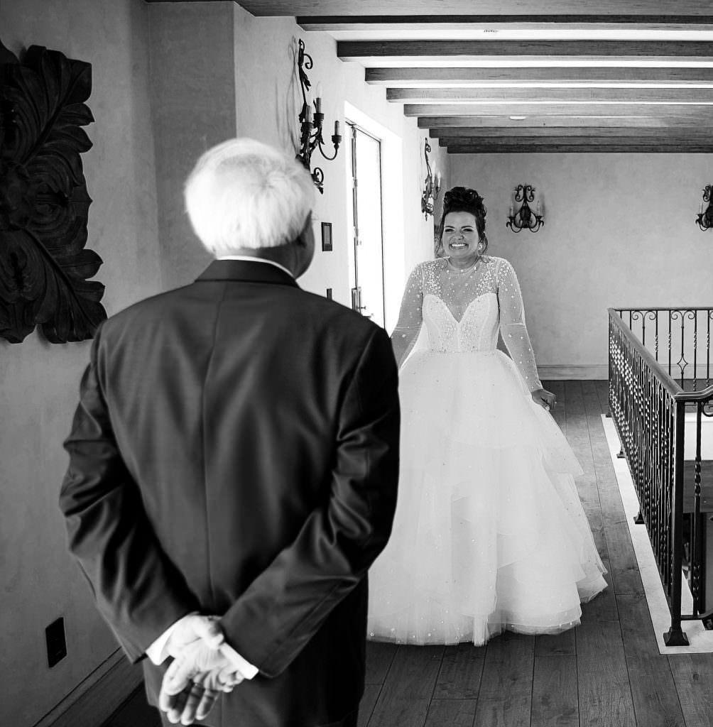 A black and white photo of a bride and her father