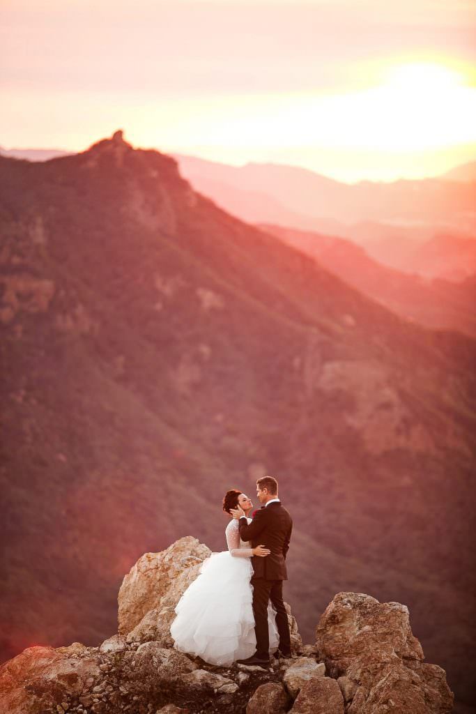 A man in a suit and tie is smiling for the camera