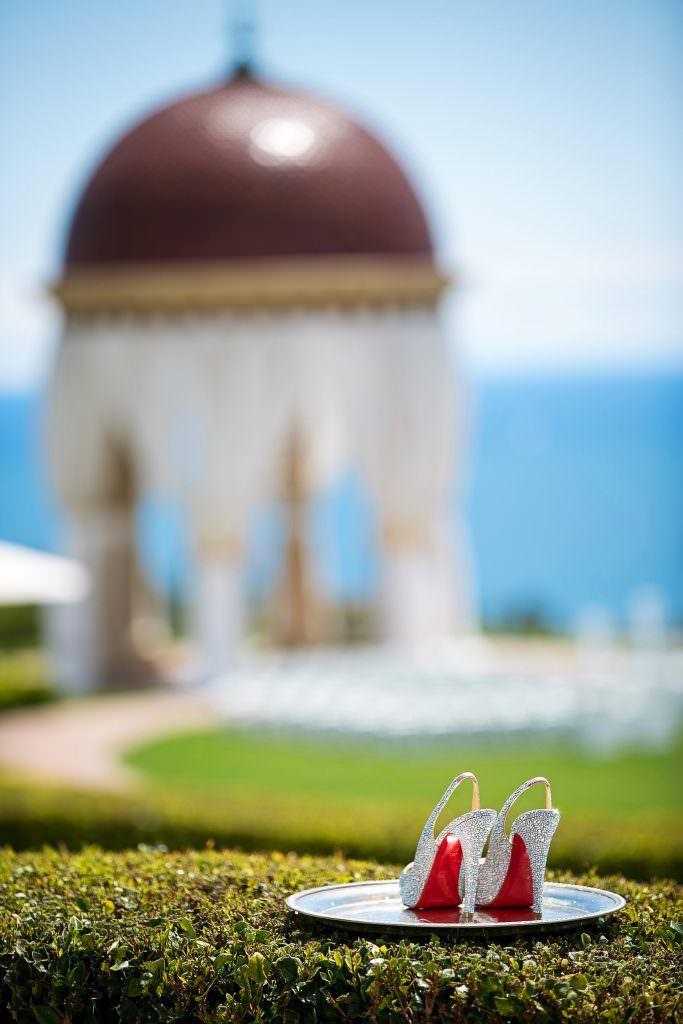 A pair of shoes on a plate with a dome in the background.
