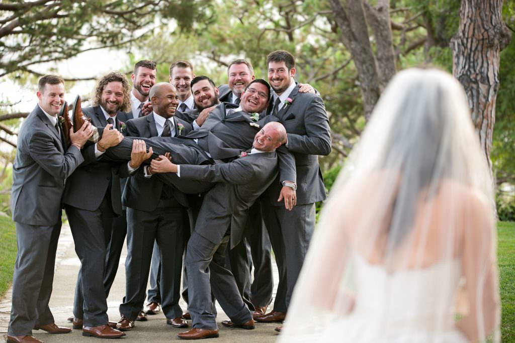 A bride and her groomsmen are posing for a picture at Wayferers Chapel.