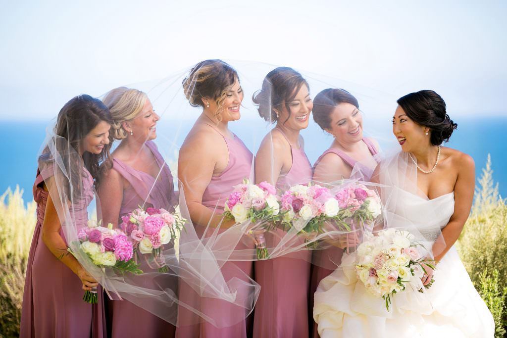 A bride and her bridesmaids are posing for a picture in Palos Verdes.