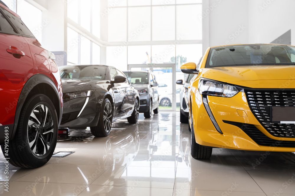 Person wearing pink gloves sprays and wipes a white bathroom sink with a green cloth.