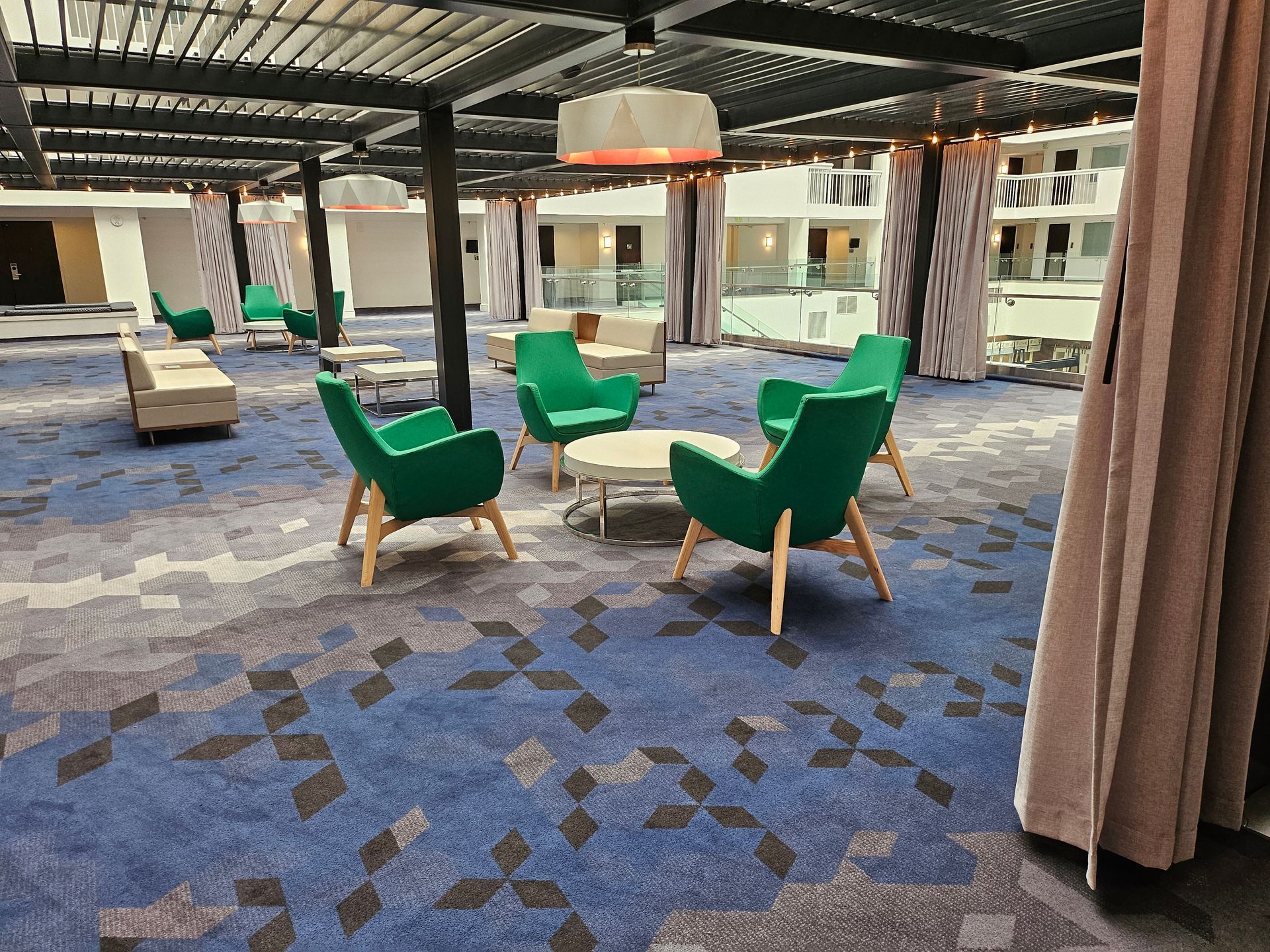 A person in jeans and yellow gloves holding a blue bucket with cleaning supplies in a blurred, blue-lit hallway.