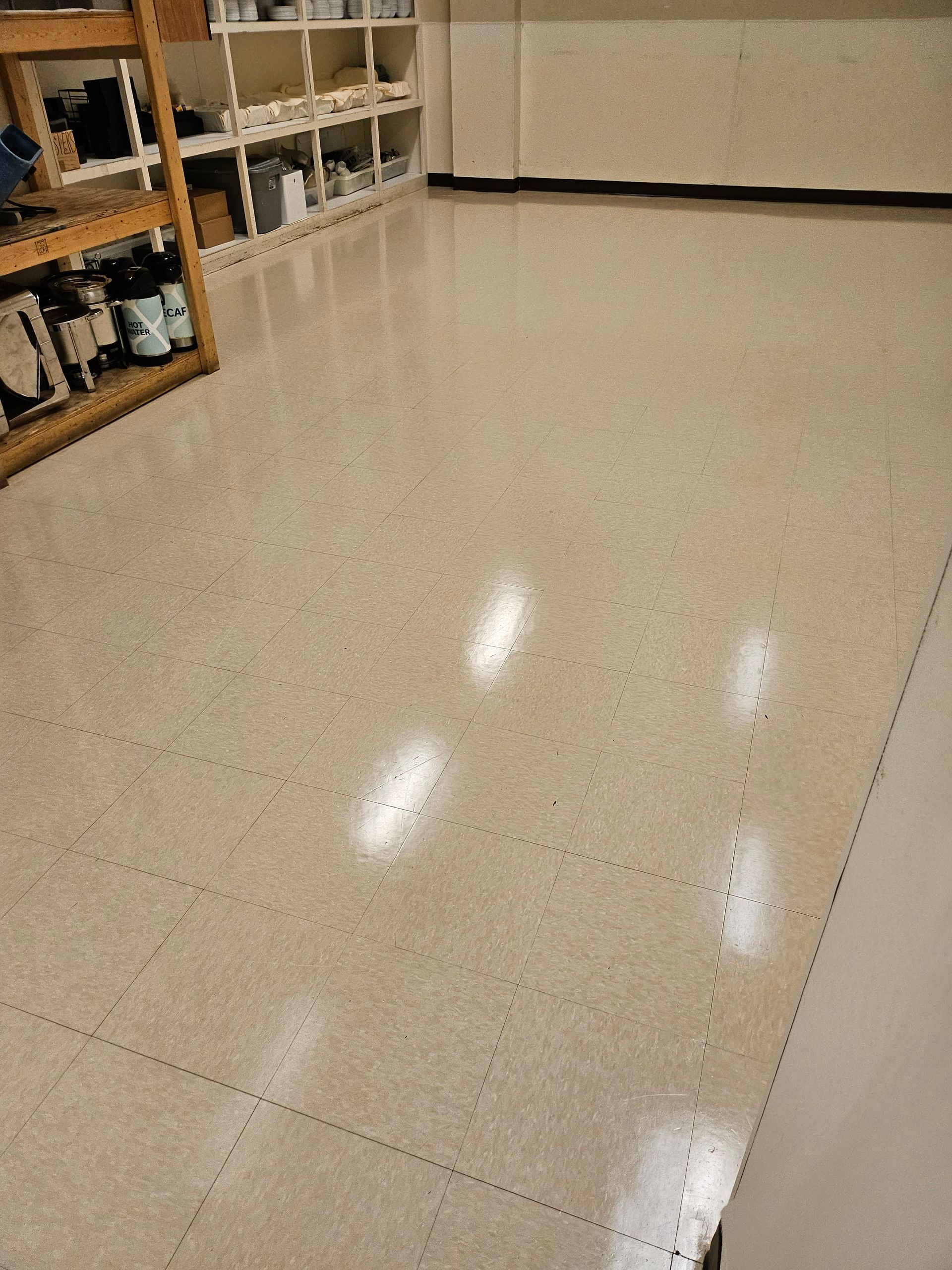 Person steaming white tile backsplash with steam cleaner.