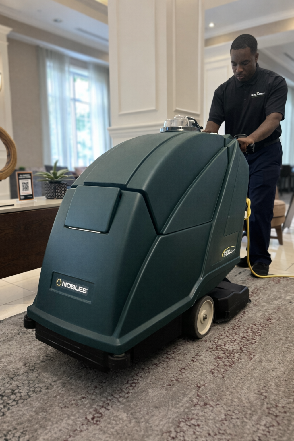 Hands in blue gloves cleaning a sofa cushion with a handheld upholstery cleaner.