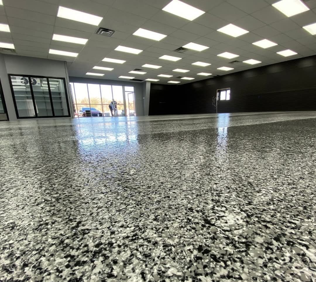 Blue-gloved hands wiping a white desk with a yellow cleaning cloth.