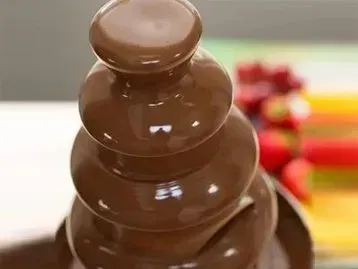 A chocolate fountain is stacked on top of each other on a table.