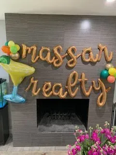 A bunch of balloons are sitting on a table in a living room.