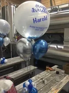 A room with a table and balloons in it.