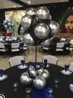 A table set for a party with balloons on it.