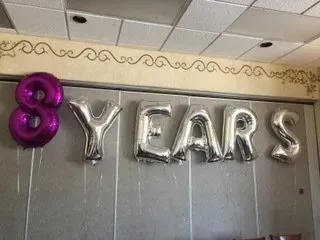 The word years is made of balloons on a wall.