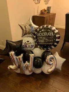 A bunch of balloons are sitting on the floor in a room.