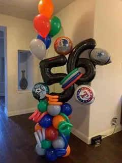 A bunch of balloons are stacked on top of each other in a room.