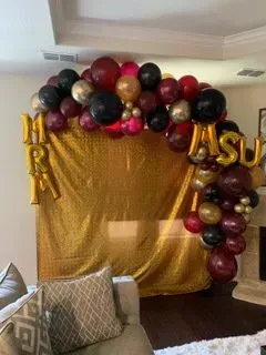 A living room filled with balloons and a couch.