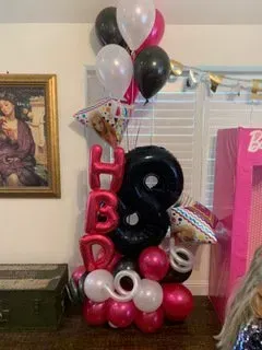 A bunch of balloons are stacked on top of each other in a room.