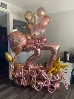 A bunch of balloons are sitting on the floor in a room.