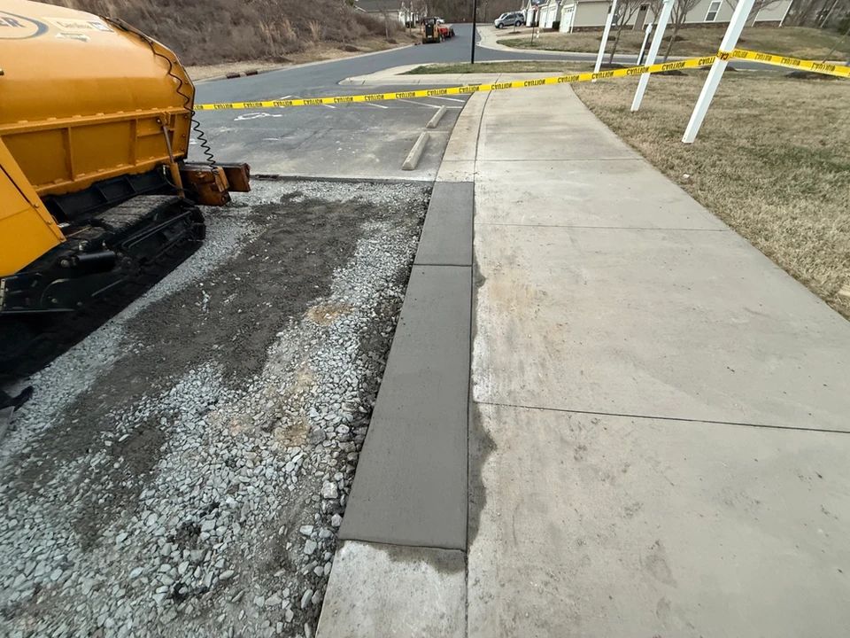 A yellow truck is parked on the side of the road next to a sidewalk.