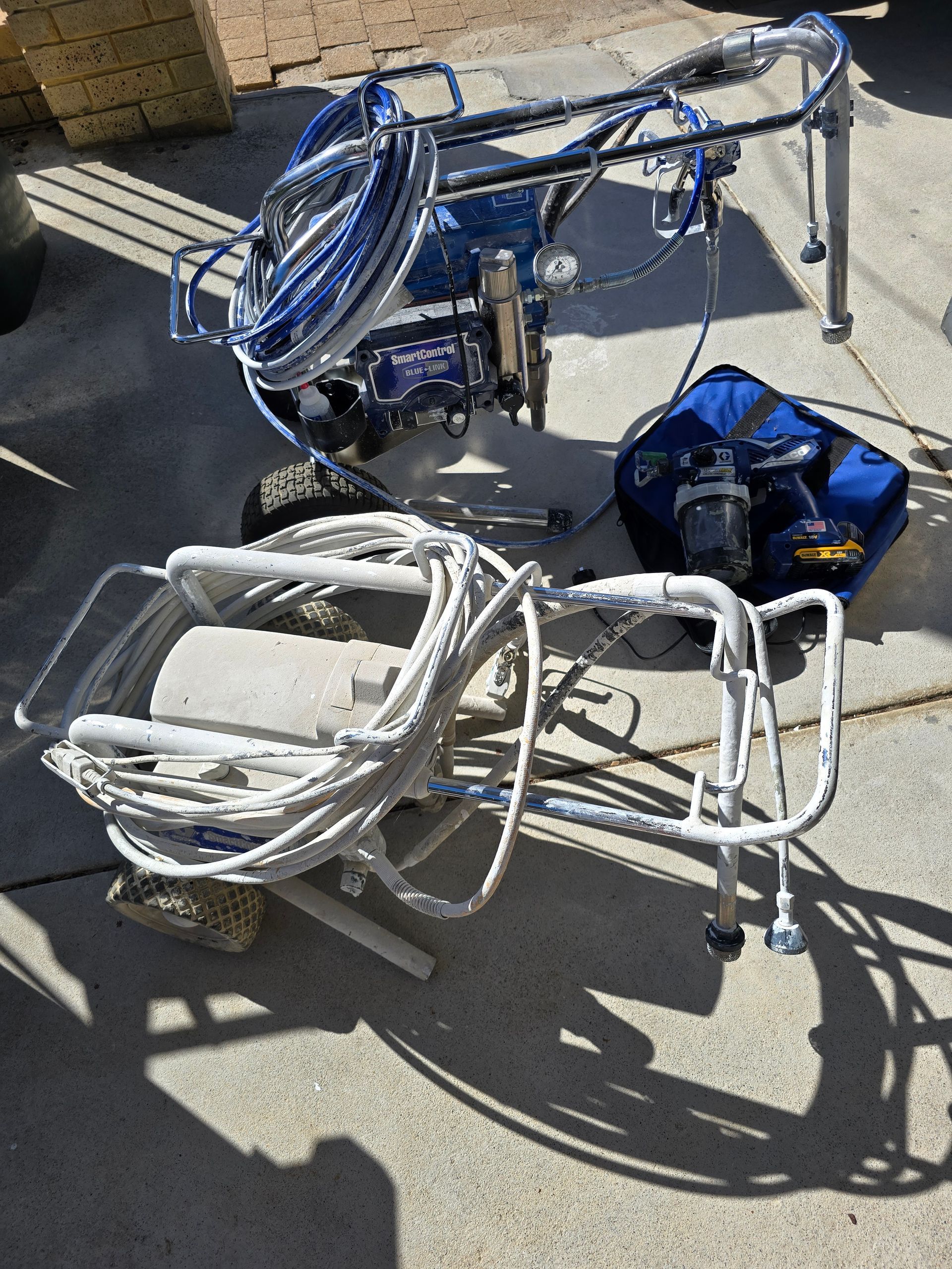 A person is spraying paint on a metal structure.