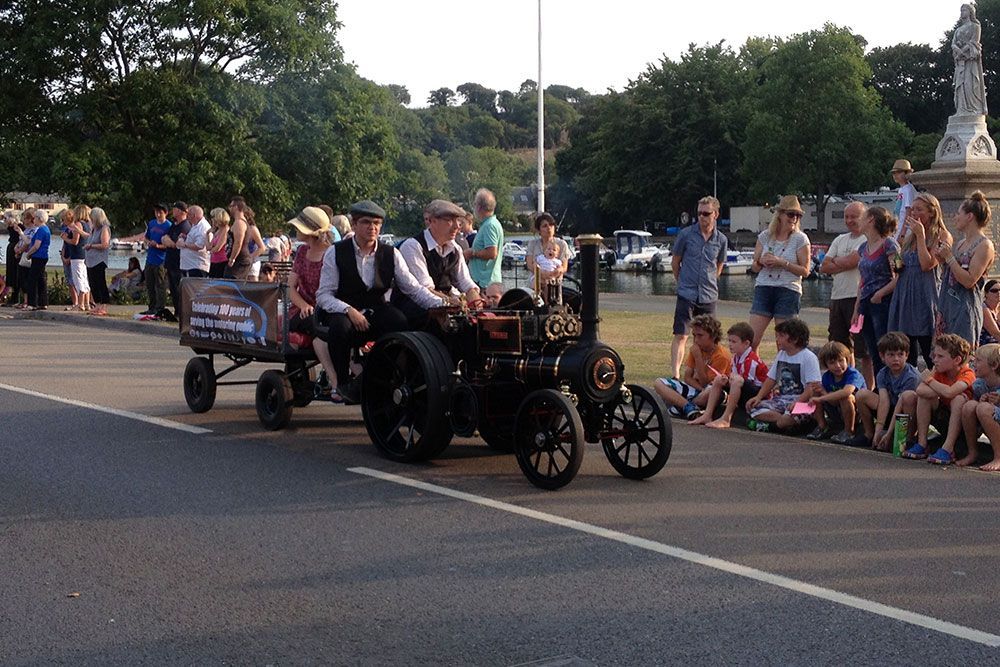 A group of people are riding on a wagon in a parade.