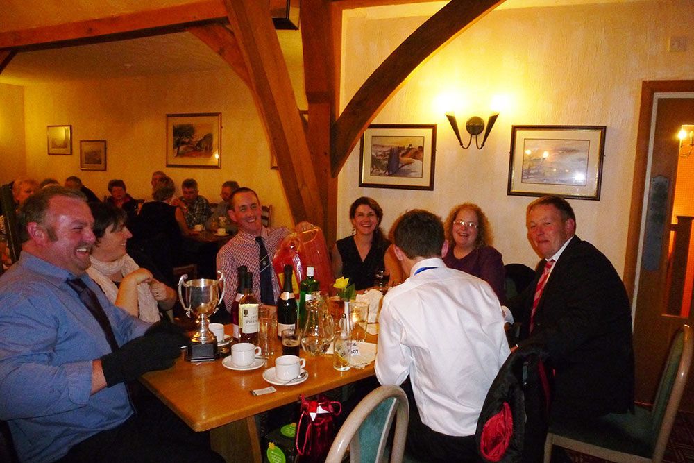 A group of people are sitting at tables in a restaurant