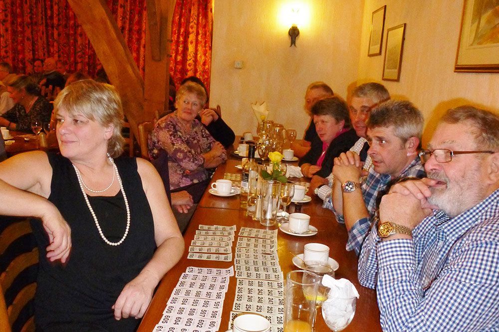 A group of people are sitting at a long table