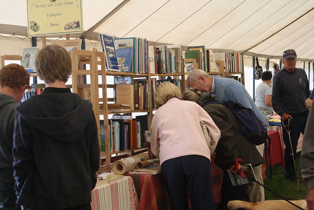 A group of people are looking at books in a library