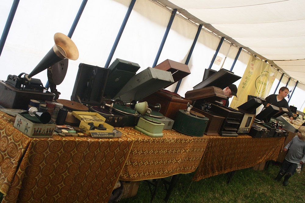 A table with a lot of old record players on it