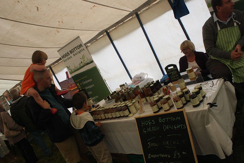 A man is carrying a child on his shoulders at a market