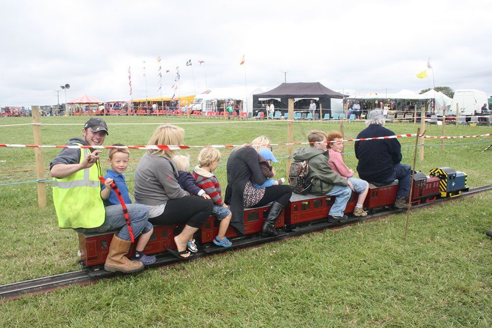 A group of people are riding on a small train.