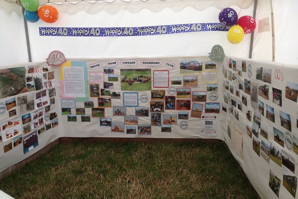 A wall with a lot of pictures and balloons on it