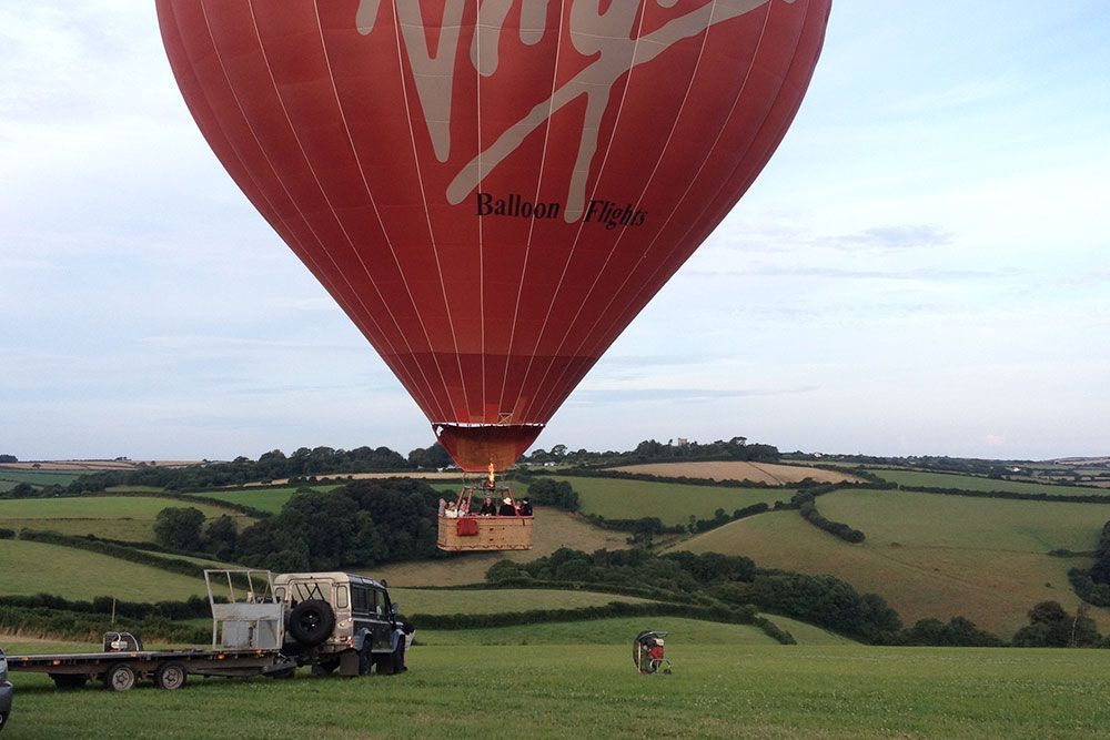 A red hot air balloon with virgin written on it
