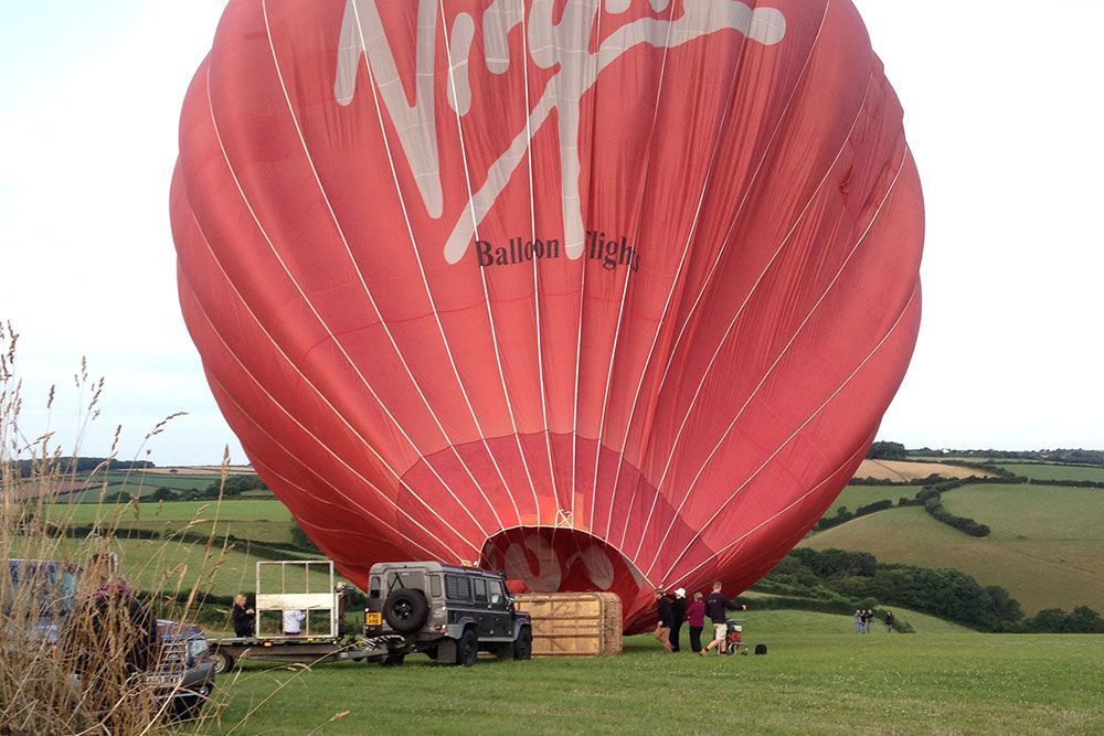 A red hot air balloon with virgin written on it